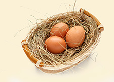 eggs sitting in straw in basket